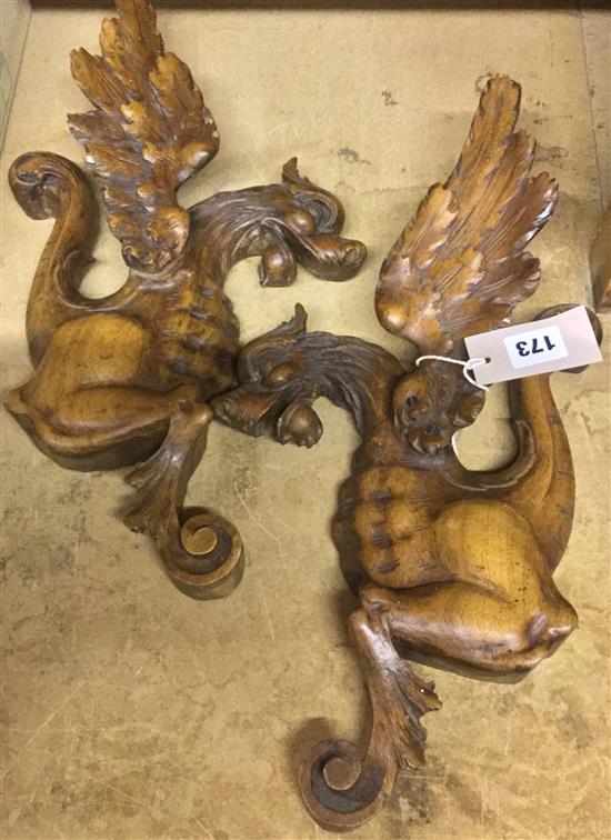 Pair of carved wood plaques in the form of griffins